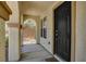 Covered entry featuring an arched doorway and a dark-colored, paneled front door at 10804 Mason Hill Ave, Las Vegas, NV 89166