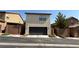 Exterior view of a two-car garage with a black door and a low-maintenance yard at 10804 Mason Hill Ave, Las Vegas, NV 89166