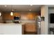 Kitchen features stainless steel appliances, wood cabinets, and a breakfast bar at 10804 Mason Hill Ave, Las Vegas, NV 89166