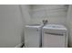 Convenient laundry room with modern washer and dryer, as well as overhead shelving for added storage at 10804 Mason Hill Ave, Las Vegas, NV 89166