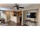 Open concept living room with hardwood floors, a ceiling fan, and a TV at 10804 Mason Hill Ave, Las Vegas, NV 89166