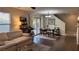 Cozy living room with a sofa, dining table, and a sliding glass door to the backyard at 10804 Mason Hill Ave, Las Vegas, NV 89166