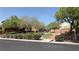 Street view of homes with lush landscaping and blooming roses at 10804 Mason Hill Ave, Las Vegas, NV 89166