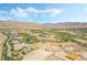 Aerial view showcasing a golf course community with desert landscaping and mountain views at 10919 Vista Altura Ave, Las Vegas, NV 89135