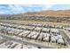 Aerial view of a new home community with modern designs, desert landscaping and mountain views at 10919 Vista Altura Ave, Las Vegas, NV 89135