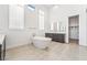 Elegant bathroom with a freestanding tub, modern fixtures, and natural light at 10919 Vista Altura Ave, Las Vegas, NV 89135