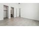 An empty bedroom with tile floors and access to a bathroom and closet at 10919 Vista Altura Ave, Las Vegas, NV 89135