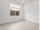 A bright and empty bedroom with a window at 10919 Vista Altura Ave, Las Vegas, NV 89135