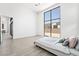 Bright bedroom with minimalist design and a large window offering backyard views at 10919 Vista Altura Ave, Las Vegas, NV 89135