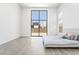 Minimalist bedroom with floor-to-ceiling windows and simple, modern decor at 10919 Vista Altura Ave, Las Vegas, NV 89135