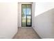 Modern entryway showcasing a tall glass door and sleek tiled flooring at 10919 Vista Altura Ave, Las Vegas, NV 89135