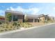 Contemporary home with a manicured yard, showcasing a brick driveway and desert landscaping at 10919 Vista Altura Ave, Las Vegas, NV 89135