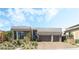 Modern home showcasing neutral colors, a front yard with new landscaping, and a brick driveway at 10919 Vista Altura Ave, Las Vegas, NV 89135