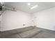 This clean, spacious garage features sealed concrete floors, white walls and trim, and an automatic garage door opener at 10919 Vista Altura Ave, Las Vegas, NV 89135