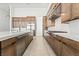 Gourmet kitchen featuring wood cabinets, an island with white countertop and stainless steel appliances at 10919 Vista Altura Ave, Las Vegas, NV 89135