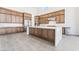 Modern kitchen featuring an island, stainless steel appliances, and wood cabinets at 10919 Vista Altura Ave, Las Vegas, NV 89135
