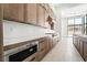 Modern kitchen featuring sleek countertops, stainless steel appliances, and light wood cabinetry at 10919 Vista Altura Ave, Las Vegas, NV 89135