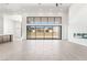 Open-concept living space featuring large windows, a sleek fireplace, and tile flooring at 10919 Vista Altura Ave, Las Vegas, NV 89135