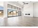 Spacious living room with high ceilings, a modern fireplace, and expansive sliding glass doors at 10919 Vista Altura Ave, Las Vegas, NV 89135