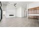 An open concept living space featuring a ceiling fan and modern built-in cabinets at 10919 Vista Altura Ave, Las Vegas, NV 89135