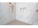 Luxurious shower with marble walls, mosaic floors, and bronze fixtures at 10919 Vista Altura Ave, Las Vegas, NV 89135
