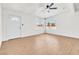 Bright living room with wood-look flooring, ceiling fan, and ample natural light from two large windows at 1121 W Monroe Ave, Las Vegas, NV 89106