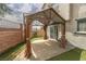 Backyard with covered patio, artificial grass, and block wall at 1135 Paradise Mountain Trl, Henderson, NV 89002
