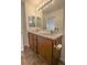 Bathroom featuring double sinks, white countertops, and dark wood cabinets at 1135 Paradise Mountain Trl, Henderson, NV 89002