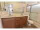 Bathroom with double sinks, wood cabinet, and shower behind a glass door at 1135 Paradise Mountain Trl, Henderson, NV 89002