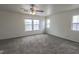 Bedroom with neutral carpet, ceiling fan and three windows for natural light at 1135 Paradise Mountain Trl, Henderson, NV 89002