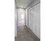 Hallway with carpet flooring, white louvered closet doors, and views into another room at 1135 Paradise Mountain Trl, Henderson, NV 89002