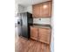 View of the refrigerator and additional kitchen cabinet with dark countertop at 1135 Paradise Mountain Trl, Henderson, NV 89002