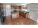 Kitchen with wood cabinets, island, wood floors and black appliances at 1135 Paradise Mountain Trl, Henderson, NV 89002