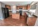 Kitchen with wood cabinets, wood floors and black appliances at 1135 Paradise Mountain Trl, Henderson, NV 89002