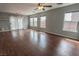Living room with lots of natural light, hardwood floors, and a ceiling fan at 1135 Paradise Mountain Trl, Henderson, NV 89002