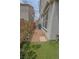Side yard featuring grass, desert landscaping, and space between homes at 1135 Paradise Mountain Trl, Henderson, NV 89002