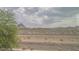 Desert landscape view with mountains, dry vegetation and cloudy sky at 1135 Paradise Mountain Trl, Henderson, NV 89002