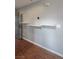 Floating shelves adorn a wall next to the entry door and a sensor in the hallway at 1135 Paradise Mountain Trl, Henderson, NV 89002