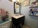 Standard bathroom with dark wood vanity with sink and standard toilet at 1152 Miller Ave, Las Vegas, NV 89106