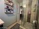 Bathroom featuring decorative shelving and glass-enclosed shower with mosaic tile accents at 1152 Miller Ave, Las Vegas, NV 89106