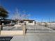 Inviting single-story home with a secure wrought iron gate and classic desert landscaping at 1152 Miller Ave, Las Vegas, NV 89106