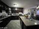 Modern kitchen featuring dark wood cabinetry, granite countertops, stainless steel appliances, and an island at 1152 Miller Ave, Las Vegas, NV 89106