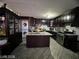 Modern kitchen featuring dark wood cabinetry, granite countertops, stainless steel appliances, and an island at 1152 Miller Ave, Las Vegas, NV 89106