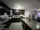 Modern kitchen featuring dark wood cabinetry, granite countertops, stainless steel appliances, and an island at 1152 Miller Ave, Las Vegas, NV 89106