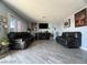 Spacious living room featuring wood-look tile flooring and ample natural light at 1152 Miller Ave, Las Vegas, NV 89106