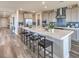 Modern kitchen with a large center island, stainless appliances, sleek countertops, and a walk in pantry at 1324 Eva Creek Dr # 29, North Las Vegas, NV 89084