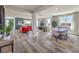 Spacious open-concept living room and dining area with neutral colors, wood floors, and ample natural light at 1324 Eva Creek Dr # 29, North Las Vegas, NV 89084