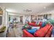 Bright open-concept living room with hardwood floors, a ceiling fan, and cozy seating area with a modern red sectional at 1324 Eva Creek Dr # 29, North Las Vegas, NV 89084