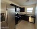 Galley kitchen features stainless steel appliances, dark cabinets and a stainless steel dishwasher at 1891 Via Del Prado St, Las Vegas, NV 89115