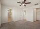 This main bedroom features a ceiling fan, carpet flooring, and ensuite bathroom at 1891 Via Del Prado St, Las Vegas, NV 89115